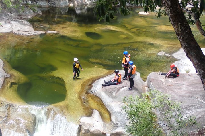 a group of people riding a motorcycle down a river