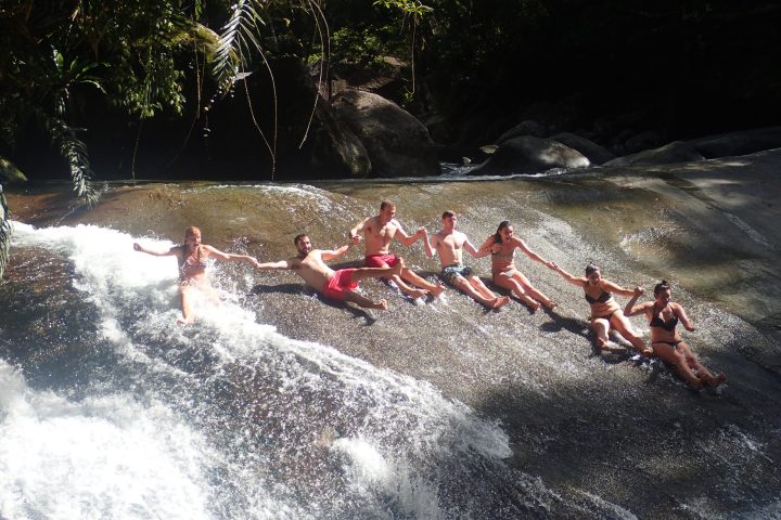 a group of people riding on top of a wave