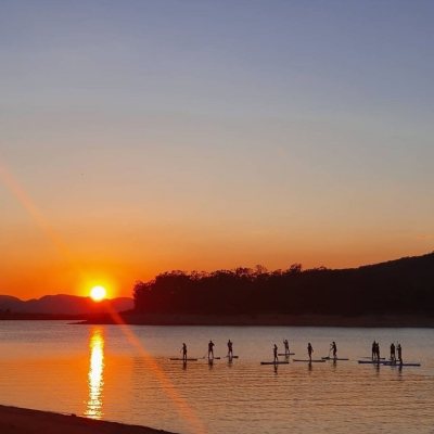 a group of people on a beach near a body of water
