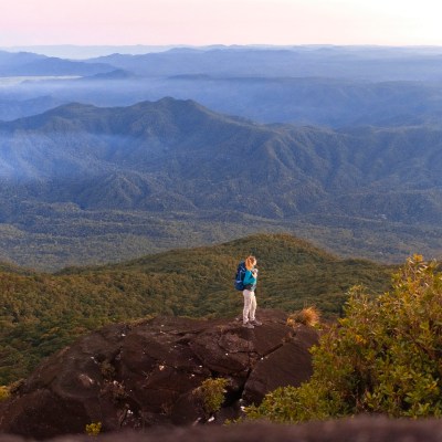 a man standing in front of a mountain