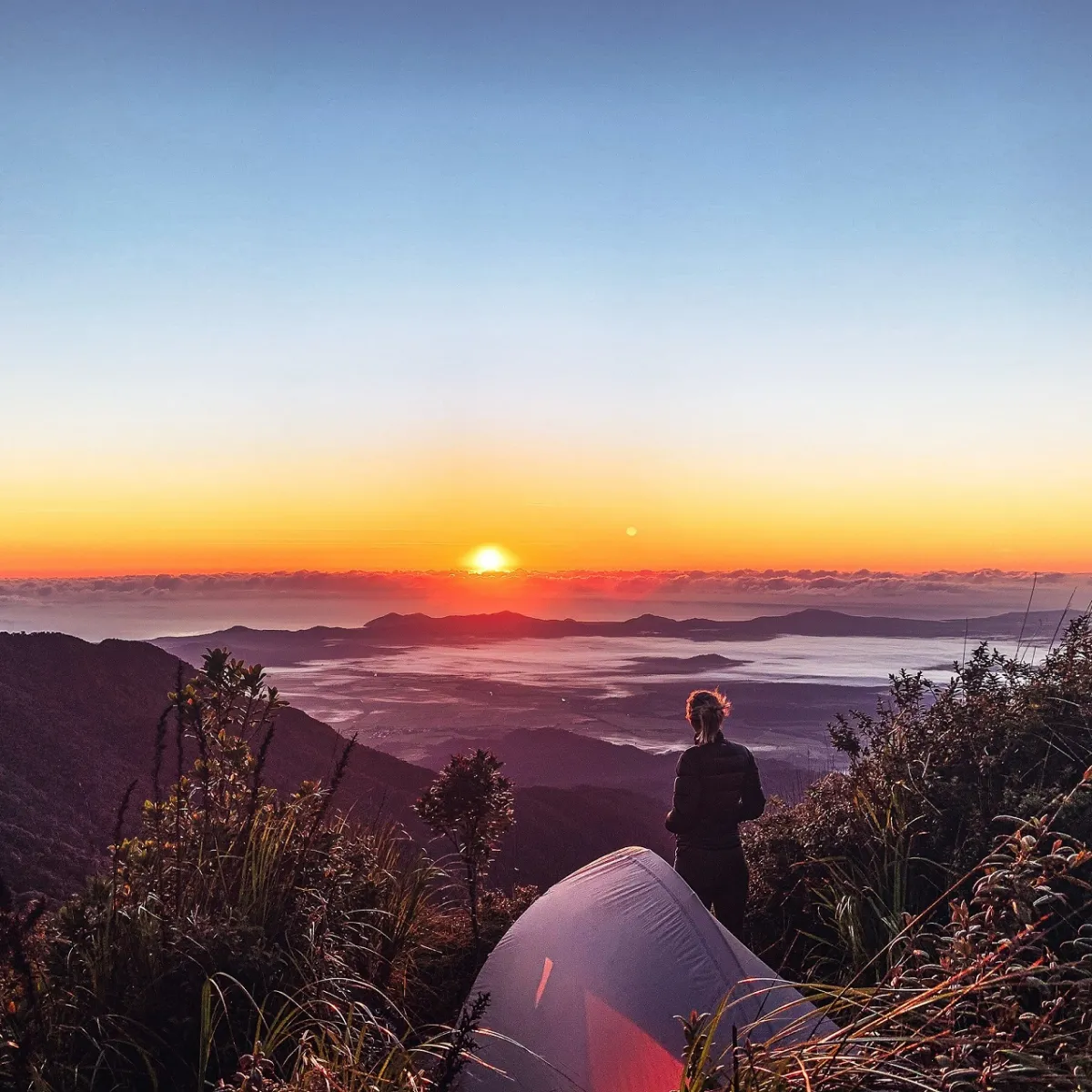 a man standing next to a body of water