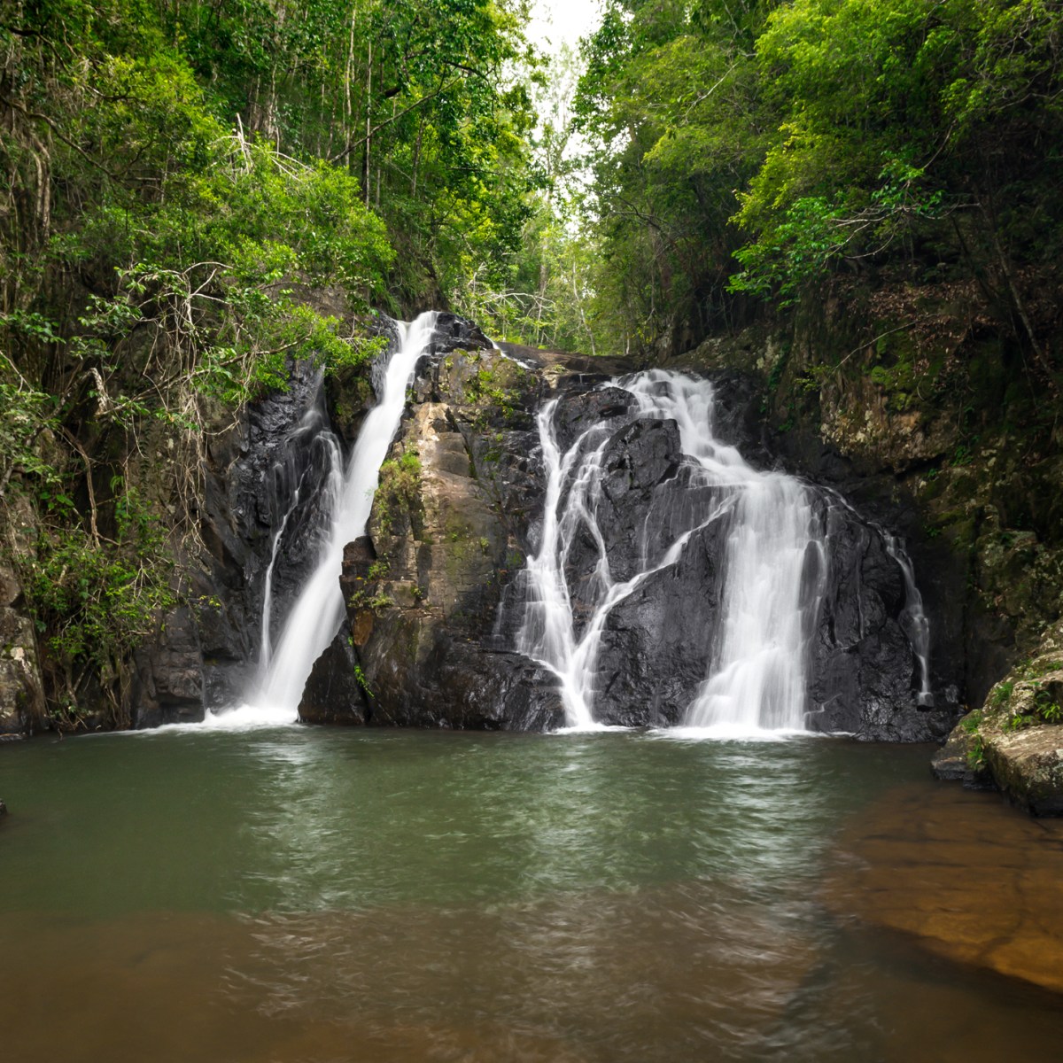 a large waterfall over a body of water