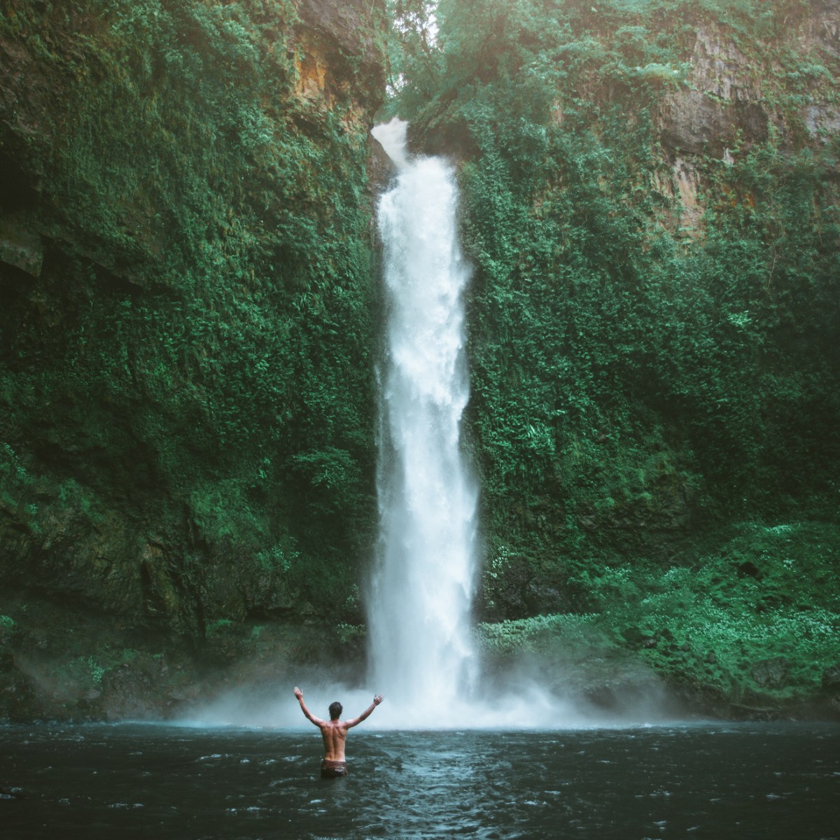 a large waterfall over a fire hydrant