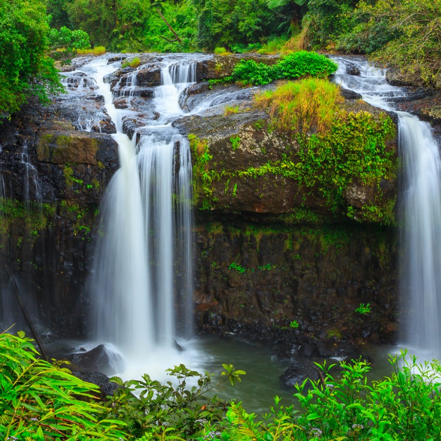 a large waterfall next to a river