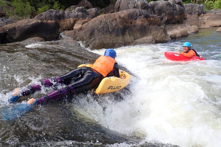 a person lying on a raft in a body of water