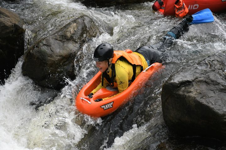 a man riding on a raft in the water
