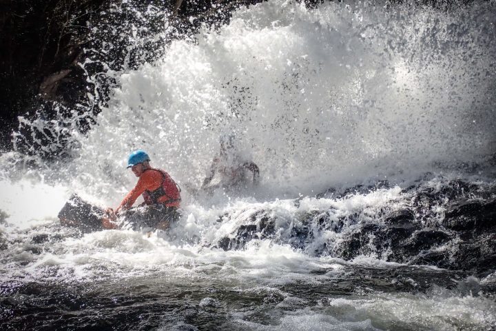 a man riding a wave on a surfboard in the water