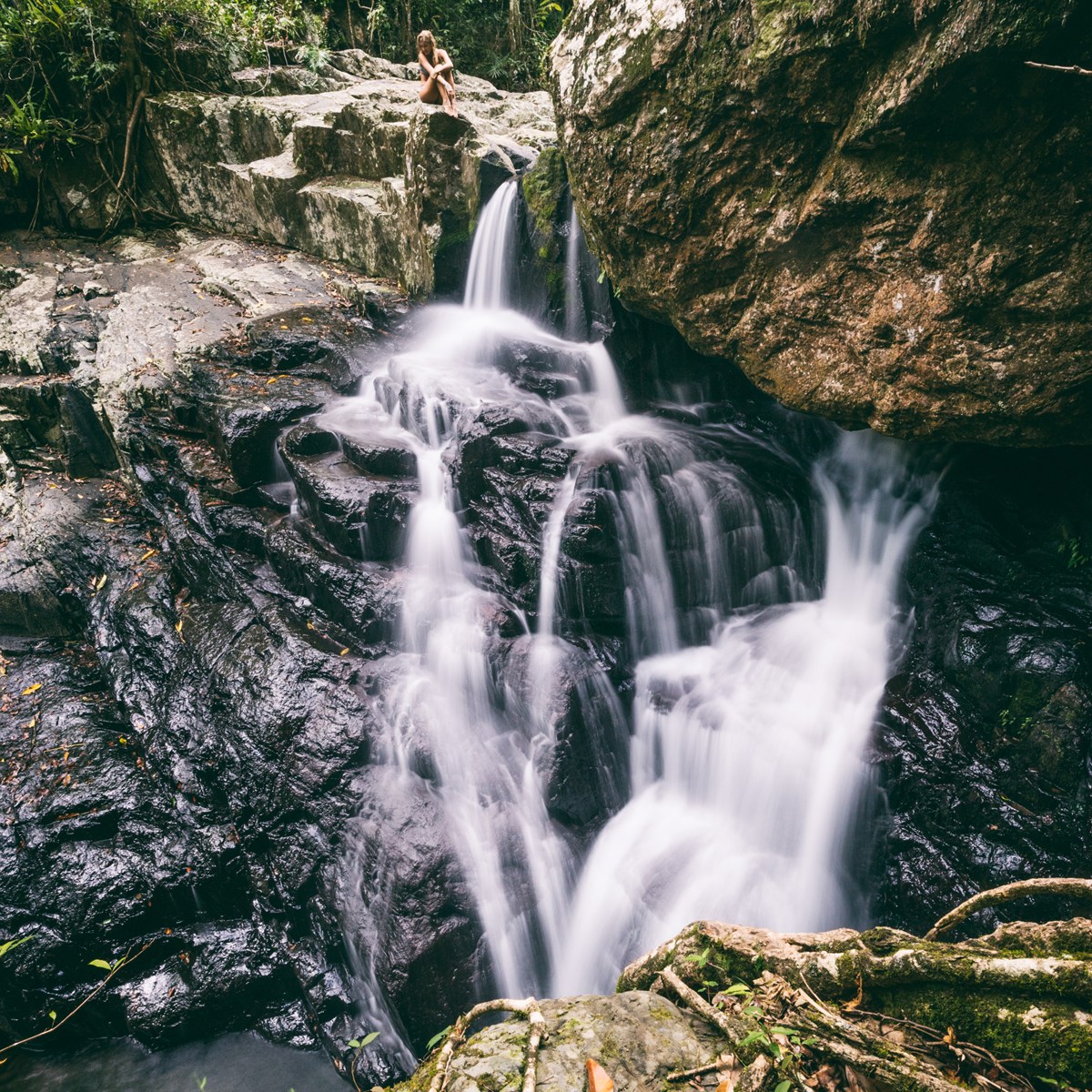 a large waterfall over some water